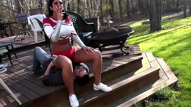 Cheerleader Christina uses a human ashtray