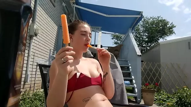 Cutie Having Fun In The Sun. Tanning, Lotion and Popsicles